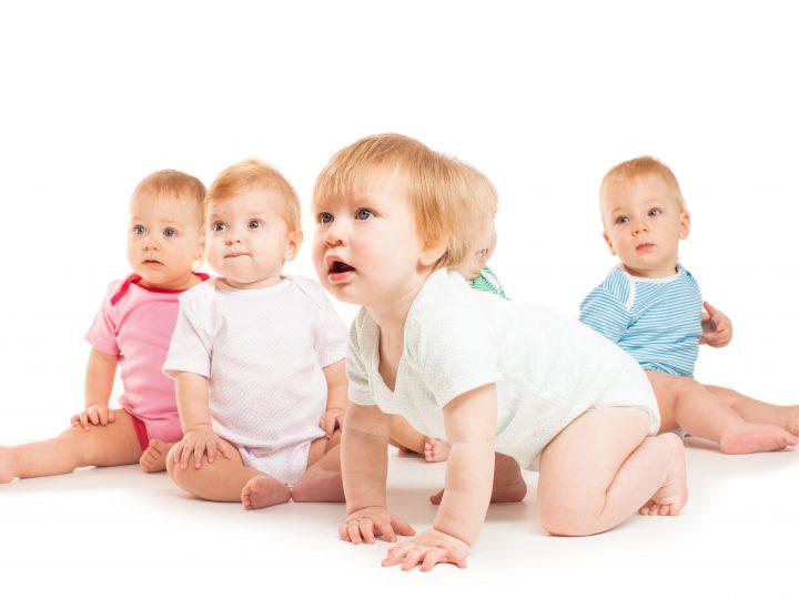 Group of cute babies crawling on floor. Isolated on white.